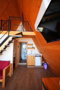 a view of a kitchen and stairs in a cabin at La Madera Resort in Turbul