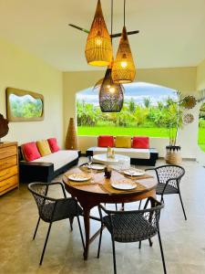 a living room with a table and chairs at Villa Santé ubud in Ubud