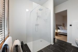 a bathroom with a glass shower with a toilet at Huys van Haeghe in Zoutleeuw +85 photos