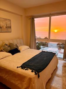 a bedroom with a bed with a view of the ocean at Luxury 2-Bedroom Apartment with amazing view - Infinity Pool and Rooftop in Building in Veracruz