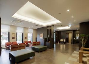 a lobby with chairs and a waiting room at Hotel Route-Inn Hita-Ekimae in Hita