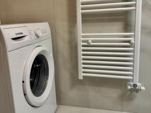 a white washer and dryer in a room at VASKO Luxury Suites 4 in Siátista
