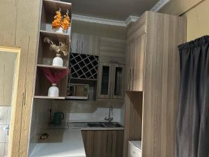 a small kitchen with a sink and a counter at Tshiamo Estate in Kuruman +13 photos