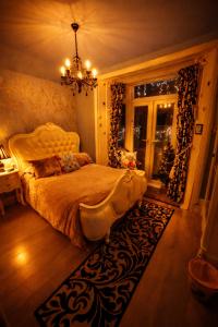 a bedroom with a bed and a chandelier at The Mirador Boutique Town House in Swansea