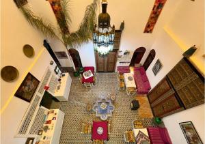 an overhead view of a living room with a table and chairs at Riad Iman in Fès