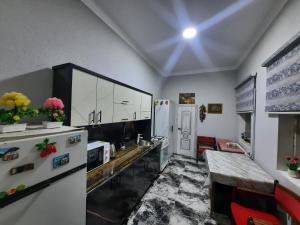 een keuken met witte kasten en een tafel. bij Garden Palace Khiva in Khiva