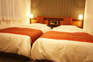Postel nebo postele na pokoji v ubytování Hotel New Ueno