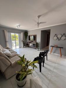 a living room with a couch and a table at Refúgio da Lagoa in Florianópolis