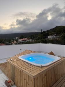 a hot tub sitting on top of a wooden deck at Refúgio da Lagoa in Florianópolis