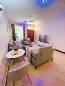 a living room with couches and a table at Lucia Homes & Stays in Dodoma