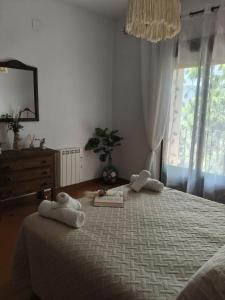 a bedroom with a large bed with towels on it at Casa Rural hasta 12 personas Alpujarra Granadina, La Almazara in Mecina Fondales