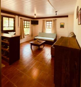a living room with a couch and a table at Cabana Rosa na mata in Imbituba