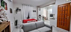 a living room with a couch and a christmas tree at La Dimora del Colle in Palo del Colle