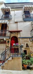 a building with a balcony with flowers on it at La Dimora del Colle in Palo del Colle