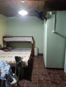 a room with two bunk beds and a chair in it at La casita del parque in Mar del Plata