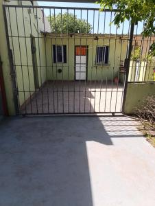 a gate in front of a yellow building at La casita del parque in Mar del Plata +4 photos