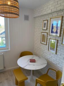a white table and chairs in a room at Central Nest in Tecuci +11 photos