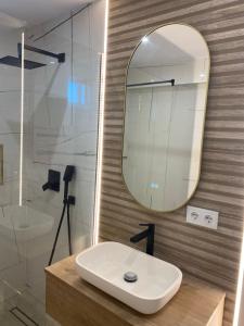 a bathroom with a sink and a mirror at Central Nest in Tecuci