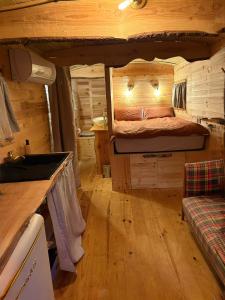 a room with a bed in a log cabin at Chicken roulotte des 3 cèdres in Cavaillon