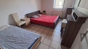 a small room with a bed and a chair at Room in Mulhouse in Mulhouse
