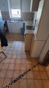 a kitchen with a sink and a tiled floor at Room in Mulhouse in Mulhouse