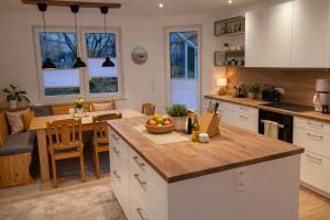 a kitchen and living room with a table and a dining room at Andi's Auszeit in Dörpen