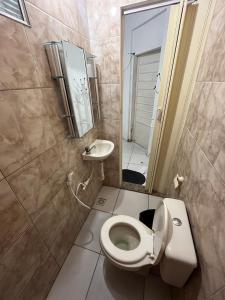 a small bathroom with a toilet and a sink at Pousada Estilo Brasil in Fortaleza +108 photos