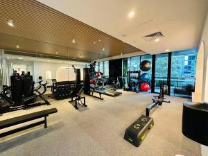 a gym with treadmills and machines in a building at Prospect Box Hill - Magnificent View 2B1B in Box Hill
