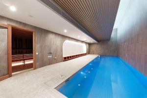 a large swimming pool in a building with a ceiling at Prospect Box Hill - Magnificent View 2B1B in Box Hill