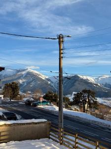 a street light with a snow covered mountain in the background at Grand 2 pièces ensoleillé in Font-Romeu
