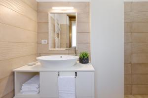 a bathroom with a white sink and a mirror at Smart Flat - Easy Milan Link in Cinisello Balsamo