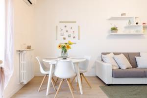 a living room with a table and a couch at Smart Flat - Easy Milan Link in Cinisello Balsamo +15 photos
