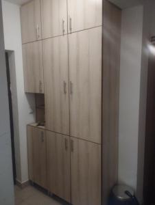 a closet with wooden cabinets in a room at APARTMENT, PLJEVLJA, NEW BUILDING 71 m2 in Pljevlja