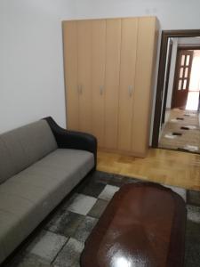 a living room with a couch and a mirror at APARTMENT, PLJEVLJA, NEW BUILDING 71 m2 in Pljevlja