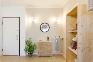 a room with white walls and a mirror and a table at Smart Flat - Easy Milan Link in Cinisello Balsamo