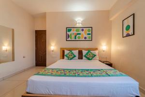 a bedroom with a large bed in a room at Treebo Akshaya Palace Inn in Mysore