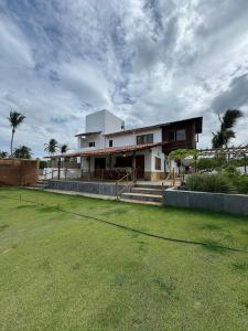 AcaraúCasa na lagoa的前面有草地的大房子