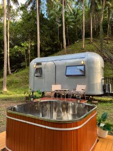 a rv parked on a deck with a table and chairs at Anora Eco-Resort Siquijor in Lazi