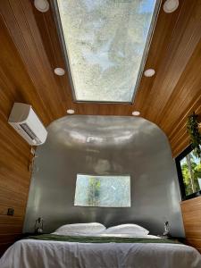 a bed in a room with a large window at Anora Eco-Resort Siquijor in Lazi