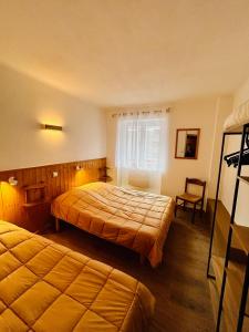 En eller flere senge i et værelse på Appartement residence les Marmottes