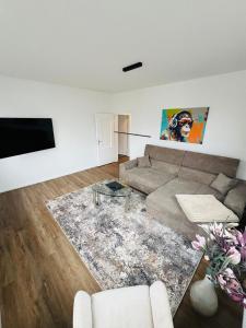 a living room with a couch and a flat screen tv at Marktblick in Esens +12 photos