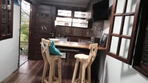 a kitchen with a counter and some chairs in it at Casa Nina in Camet Norte