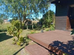 a wooden deck on the side of a house at Casa Nina in Camet Norte