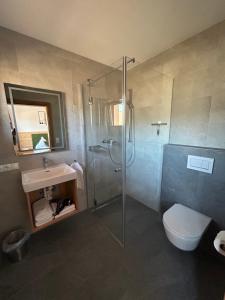 a bathroom with a shower and a toilet and a sink at Wiererhof in Fügenberg +20 photos