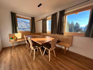 a dining room with a wooden table and chairs at Wiererhof in Fügenberg