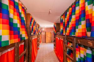 a corridor of a room with colorful walls at Casa Voyage Hostel in San Pedro de Atacama