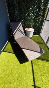 a bench sitting on top of some grass at Vue Parlement Européen - Grande terrasse au calme - Tram à 2 min - Parking in Strasbourg