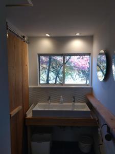 a bathroom with a large sink and a window at Nemurupa Garden Hostel and Yoga near Narita Airport 15 min Shuttle in Narita +41 photos