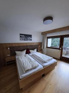 a bedroom with a large bed in a room at Berghaus Praxmarer in Längenfeld +30 photos