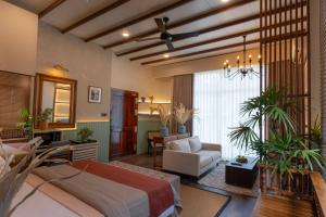 a large bedroom with a bed and a living room at Mikayla Cove in Negombo